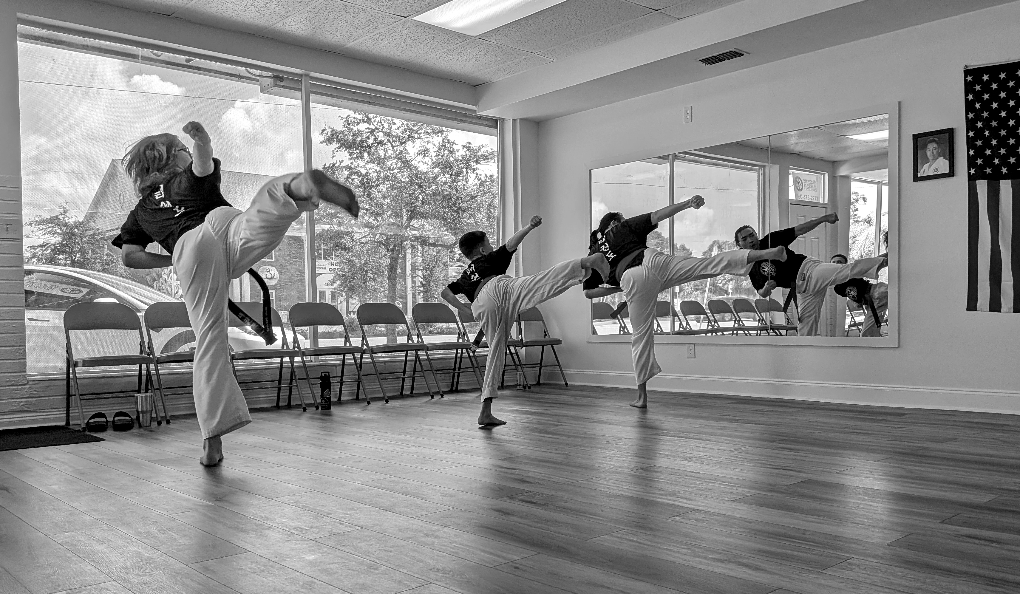 3 students performing a side snap kick